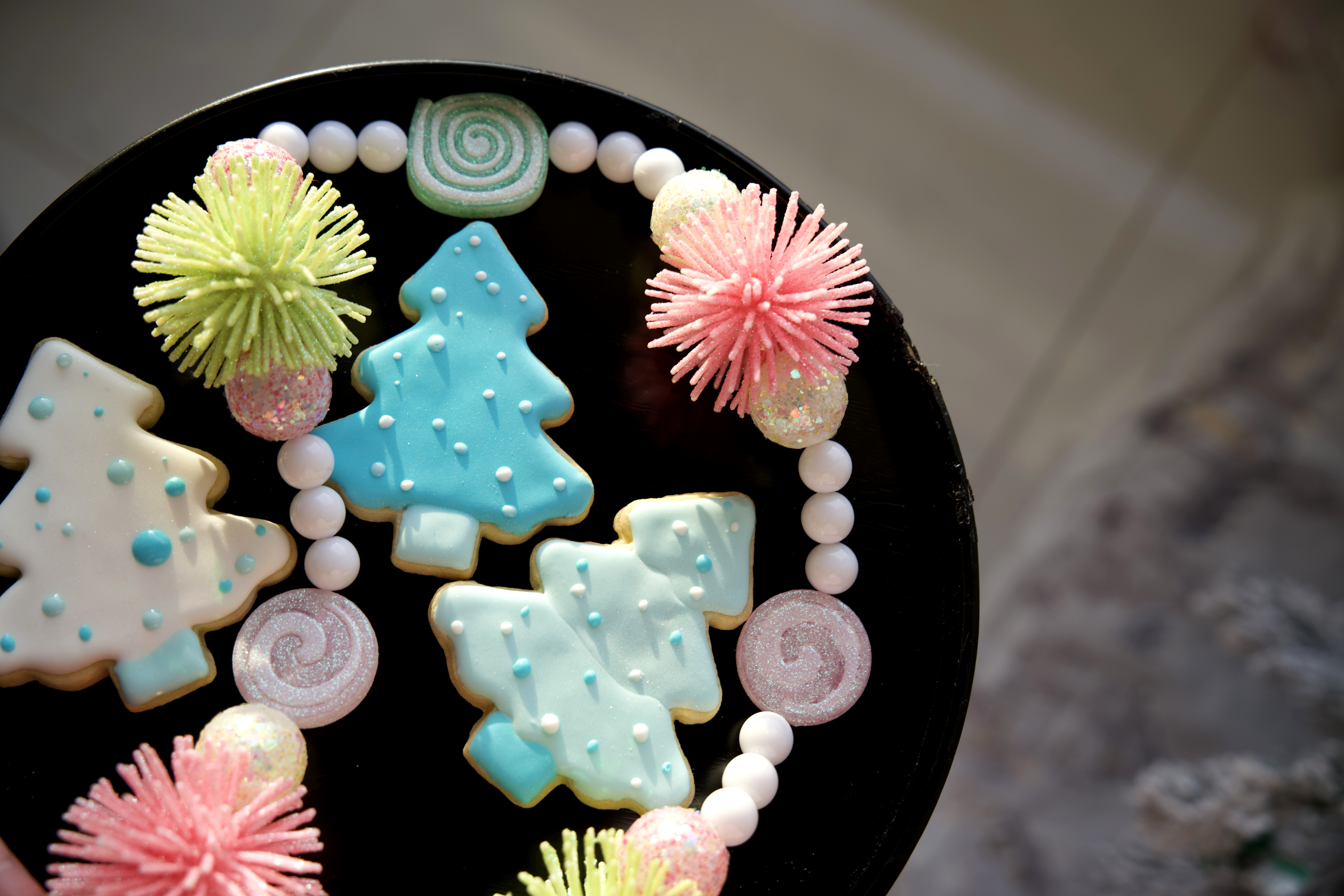 Decorated sugar cookies with blue icing and holiday decor. 
