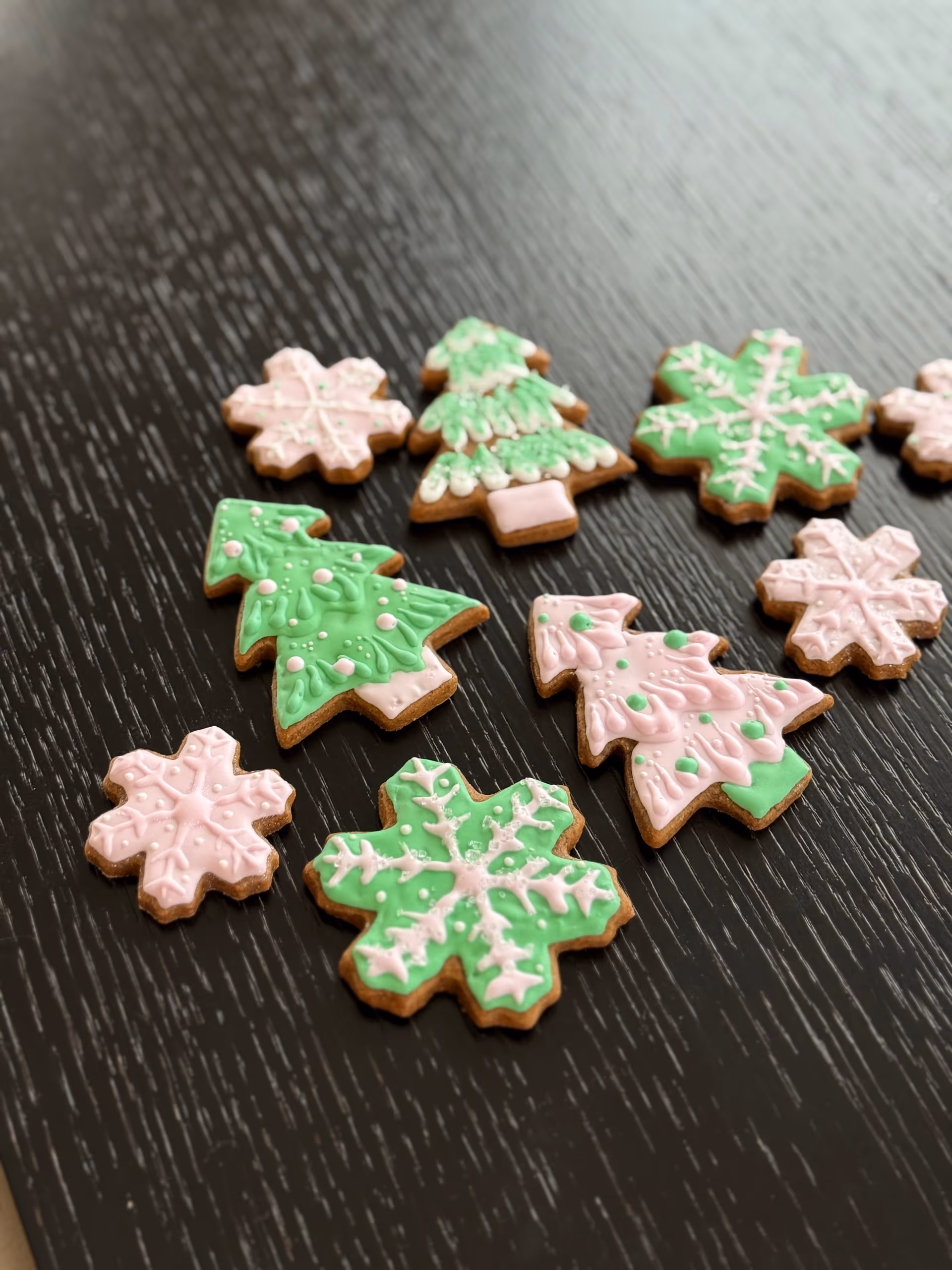 Gingerbread cookies with green, pink, and white icing.