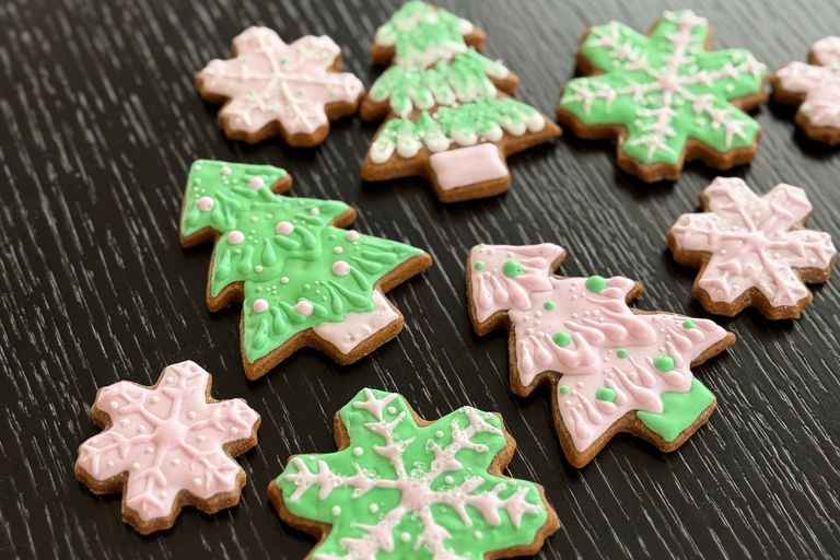 Gingerbread cookies with green, pink, and white icing.