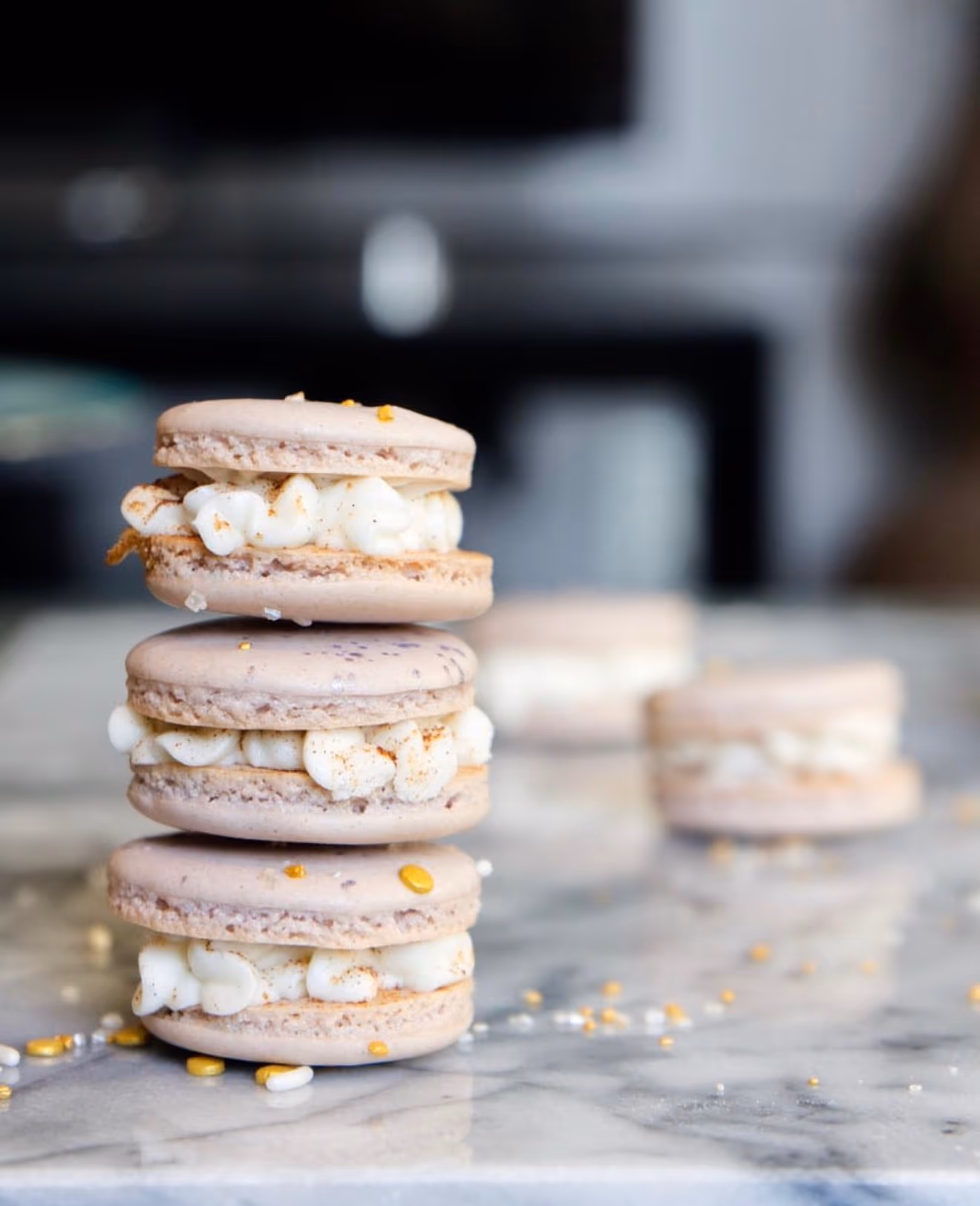 Macarons stacked on marble board