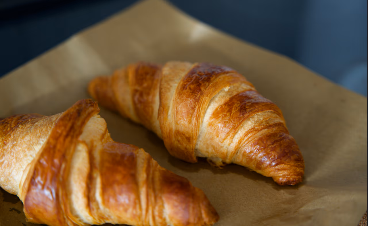 freshly baked croissant on parchment paper
