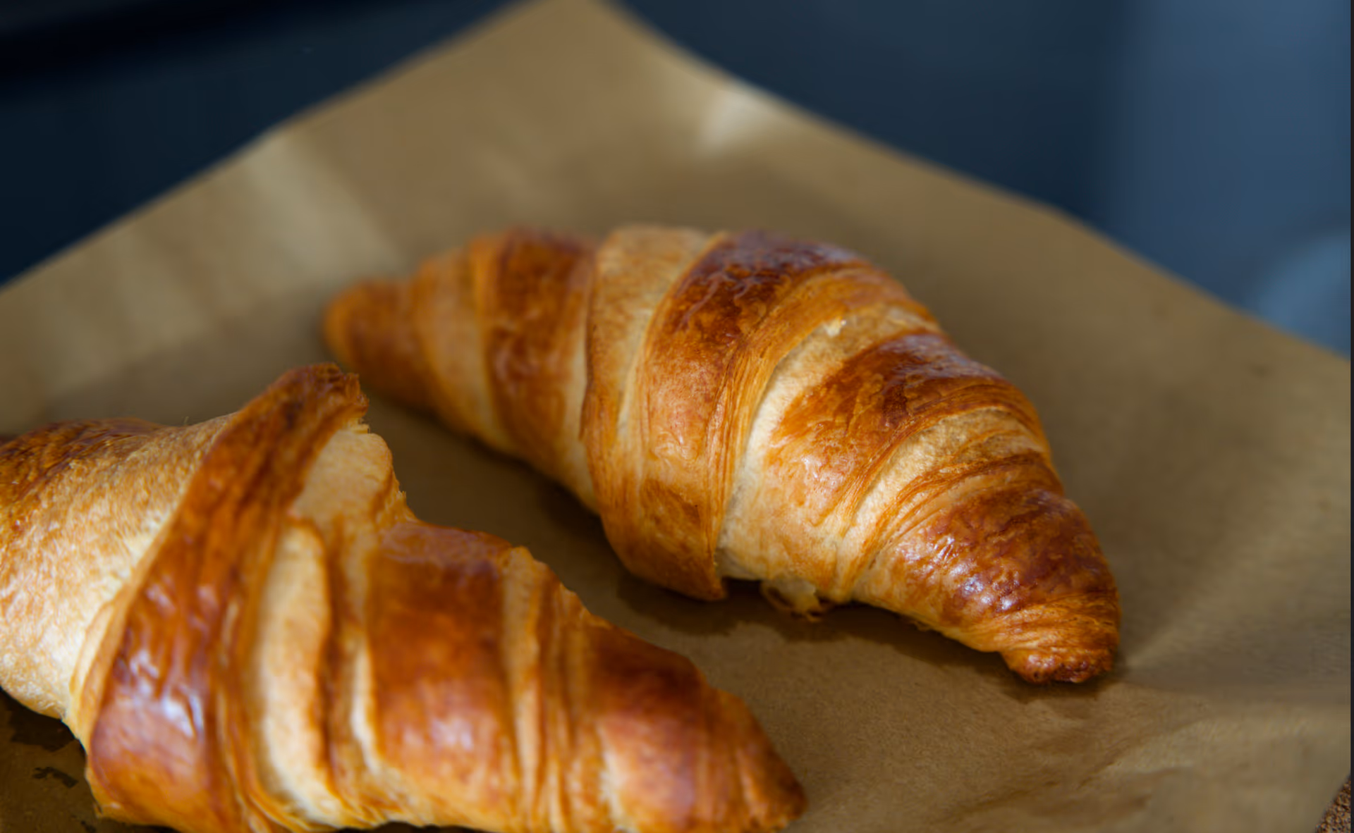 freshly baked croissant on parchment paper